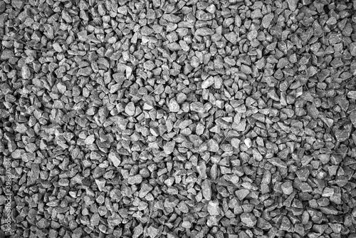 evocative black and white image of texture of pebbles on a beach
