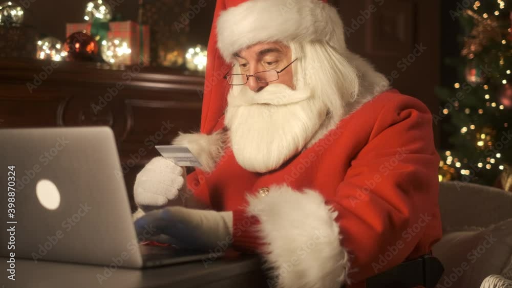 Happy Santa Claus shopping online with credit card. Online banking with smart phone. Lifestyle. Easy pay using smart phone or digital device. Communication via app for sale in shop. Modern technology