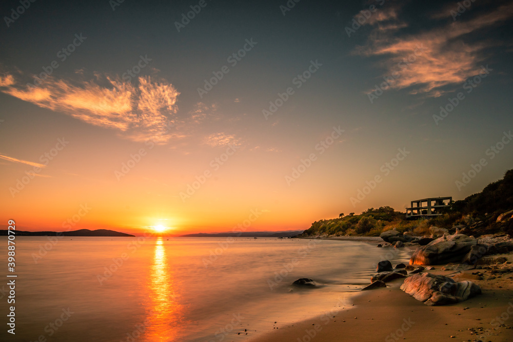 Beach in Greece, bay in the sunset, holidays by the sea, romantic

