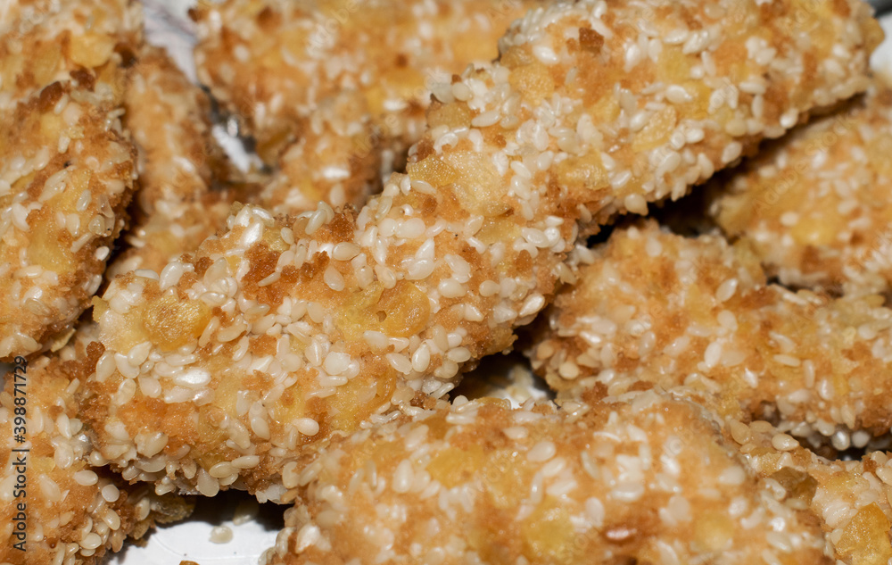 Pieces of fried chicken with sesame seeds. Delicious food