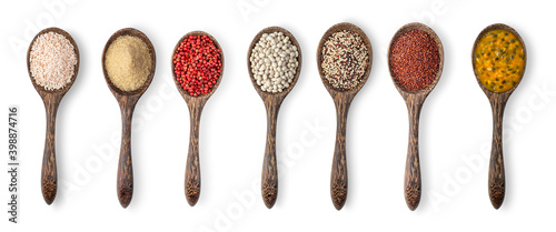 brown rice, brown sugar, red pepper, mixed raw quinoa, white beans, red quinoa, passion fruit in wood spoon isolated on white background