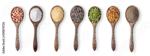 peanuts ,Pile of flour, brown rice,sunflower seeds ,Flower of Sa lae or Broussonetia kurzii Corner, beans, Perilla herb seed in wood spoon isolated on white background photo