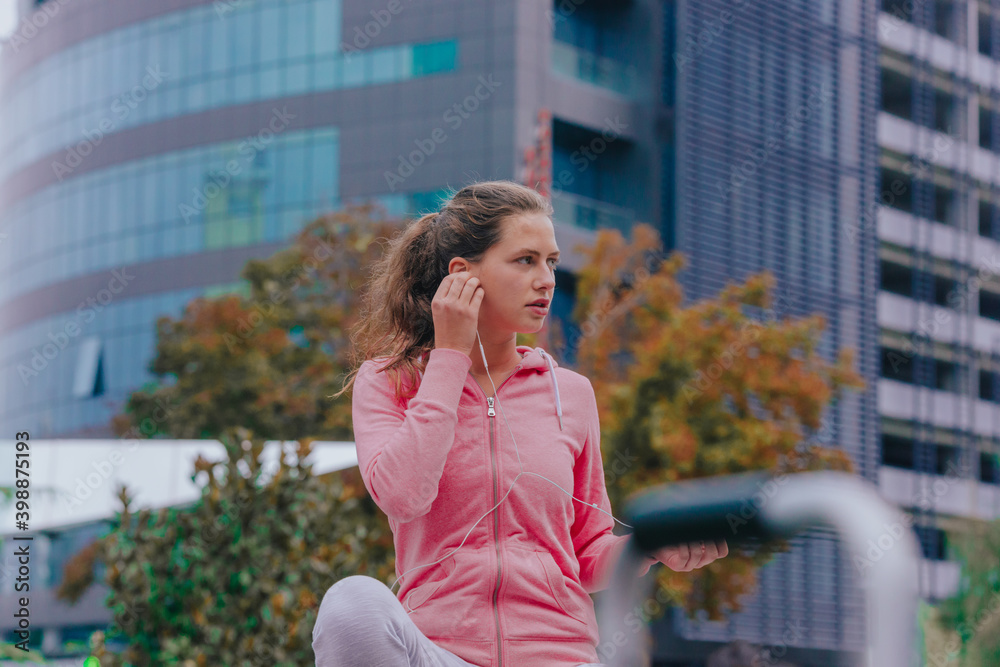 Woman in urban area with earphones Woman in urban area with earphones