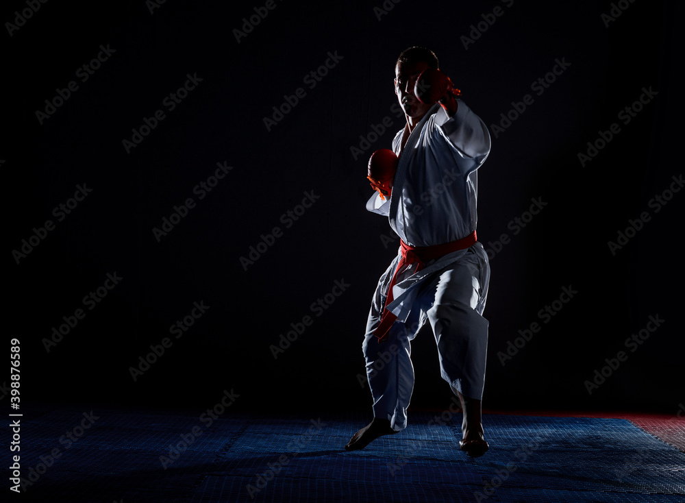 One karate kata training man isolated on dark background