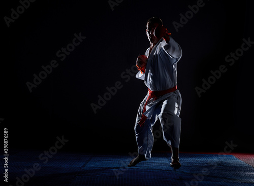 One karate kata training man isolated on dark background
