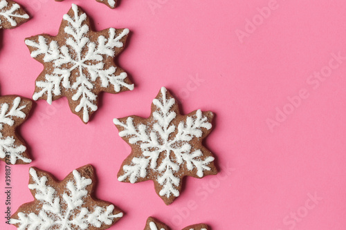 Snowflake gingerbread cookies on pink background.