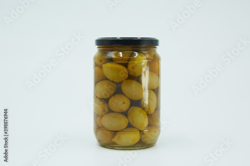 Canned green olives in a glass jar. Home canning.