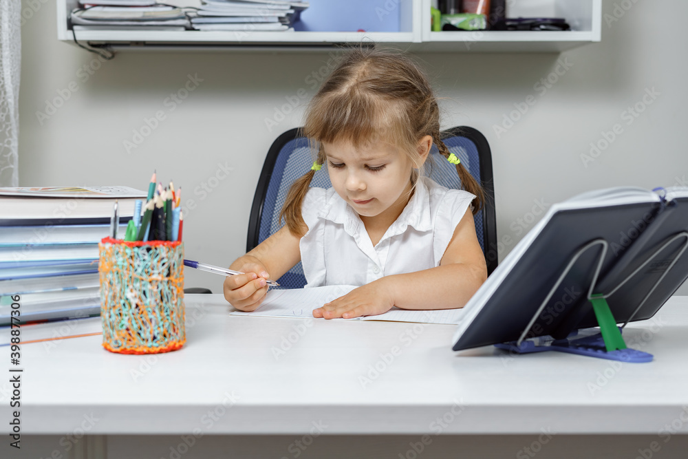 little girl doing homework at the table little girl doing homework at the table