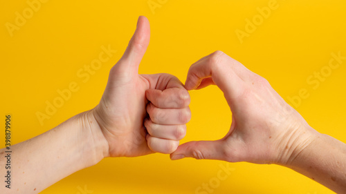 Friendzone hand sign on yellow background. Friend zone symbol. Friendzoned hands shape