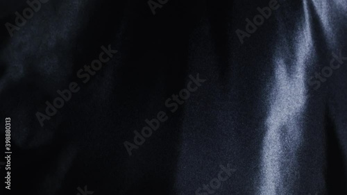 A seamless loop of an abstract black silk rippling. Ideal for luxury backgrounds, intros, outros and more. photo