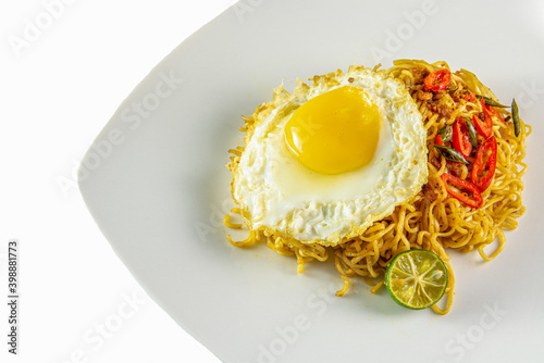 fried noodle with fride egg on the plate photo