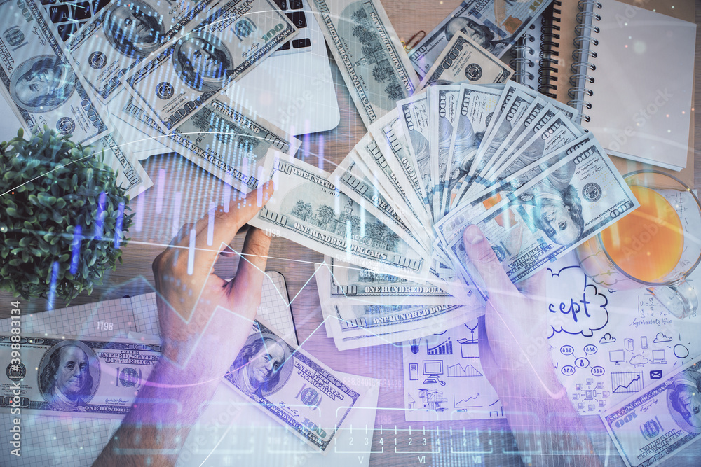 Multi exposure of financial graph drawing hologram and USA dollars bills and man hands. Analysis concept. Multi exposure of financial graph drawing hologram and USA dollars bills and man hands. Analysis concept.