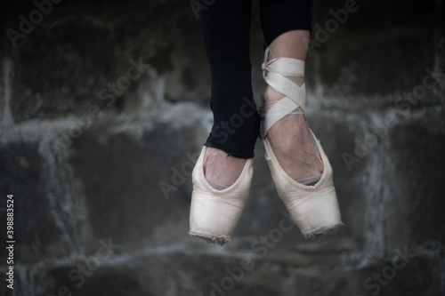 ballet feet of a person in point shoes