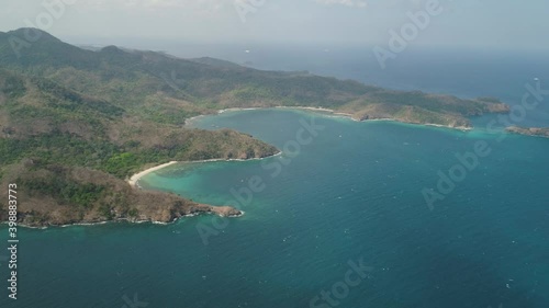 Aerial view coastline with tropical beach, island Limbones, lagoons and coral reefs. Neela cove, Philippines, Luzon. Coast ocean with turquoise water. Tropical landscape in Asia. photo