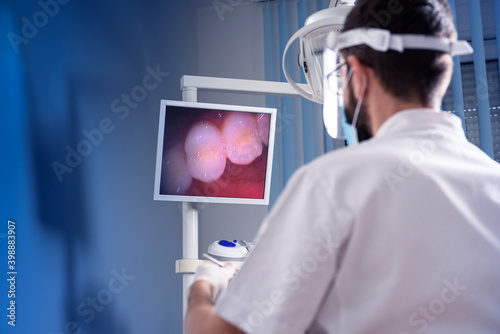 Dentist checking patient`s teeth with dental camera