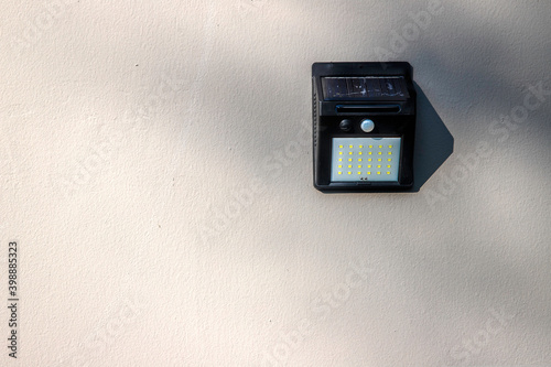 copy space of Solar-powered motion sensor light isolated on cement or concrete wall background
