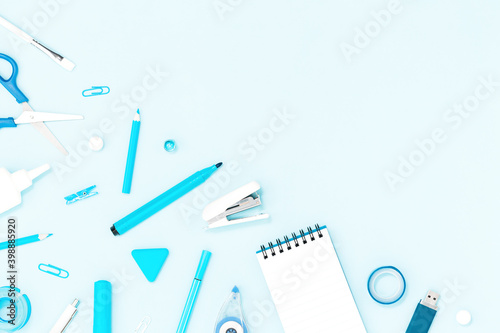 various office and school white and blue stationery on pastel trendy background as corner border. Flat lay with copy space for back to school or education and craft concept