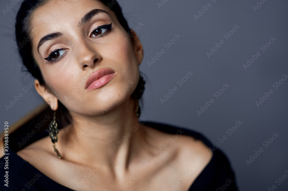 beautiful woman model in evening dress sitting on a chair hairstyle makeup earrings beautiful woman model in evening dress sitting on a chair hairstyle makeup earrings