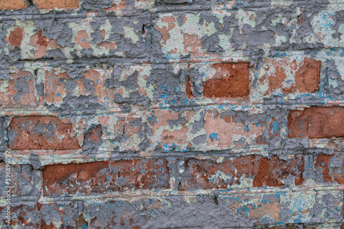 Old brick wall for a backdrop. Peeling paint.