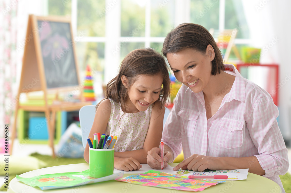 Cute girl with mother drawing at home Cute girl with mother drawing at home