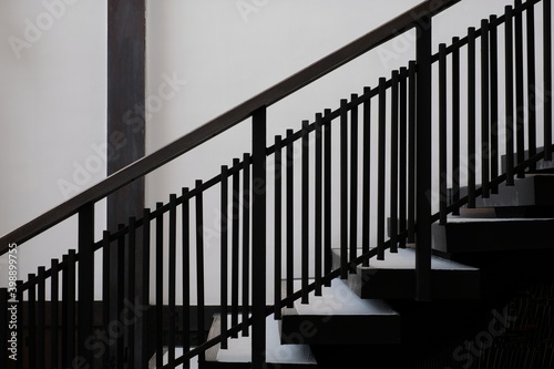 side of the black railing against the white walls