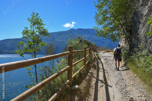 hiker at old ponale road, adventurous trail, above garda lake italy