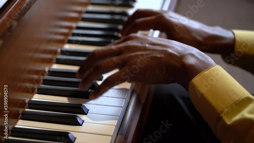 Slow motion closeup hands man skillfully softly playing a brown  piano