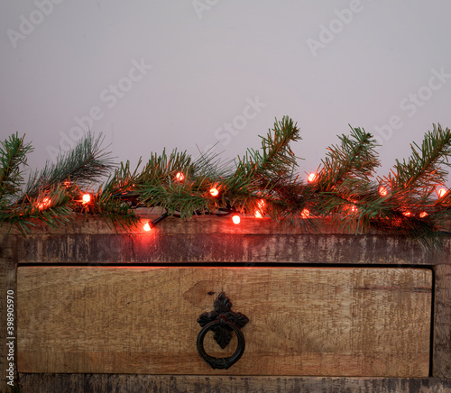 Old fashion wordrobe with christmas decoration - lights and fir branches photo