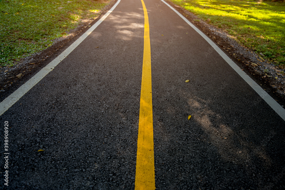 Yellow line on road with sunrise.  Start for new business