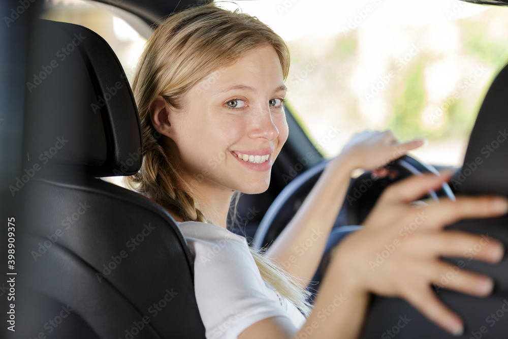 young female driving a car