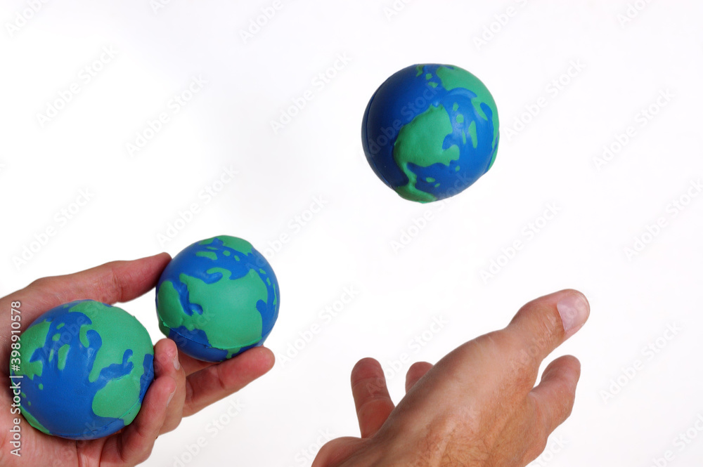 Juggling three worlds on a white background Juggling three worlds on a white background