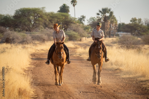 Blonde strokes horse on track beside brunette © Nick Dale