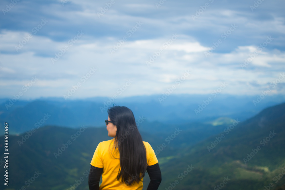 rear of happy woman wear white dress on top mountain looking view with mist and cloud at morning light Soft focus.