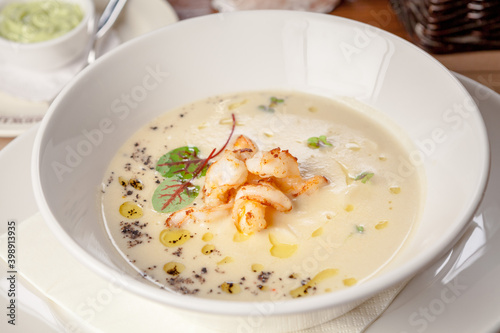 White vegetable soup with tiger-prawns