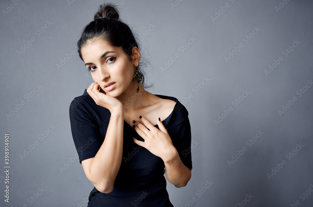 pretty brunette holding hands near face evening dress room gray wall pretty brunette holding hands near face evening dress room gray wall