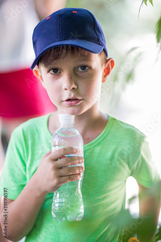 young boy with bottle of water