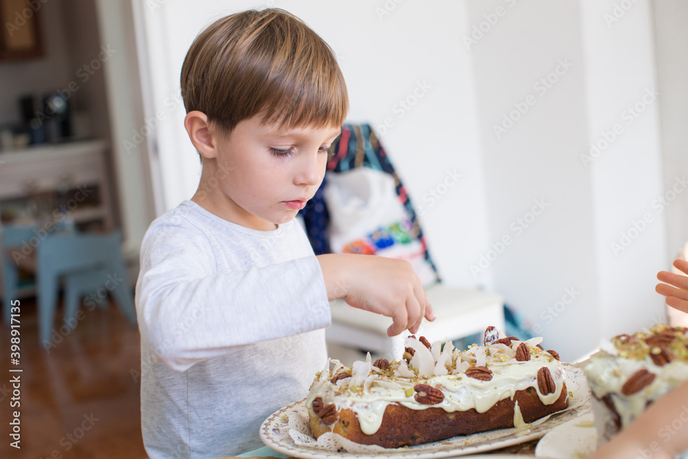 Cheerful boy in white clothes cooking pie on white background Cheerful boy in white clothes cooking pie on white background