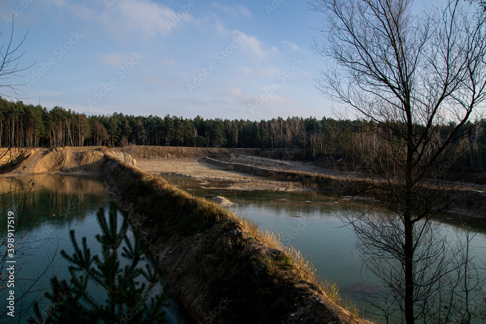 An abandoned and flooded sand or gravel mine somewhere in the Polish countryside An abandoned and flooded sand or gravel mine somewhere in the Polish countryside