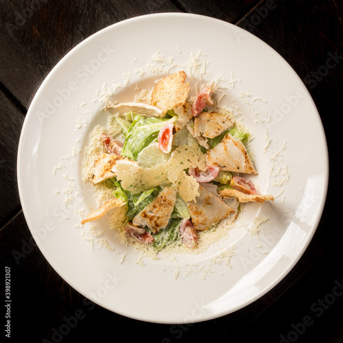 Caesar salad with chicken parmesan and croutons