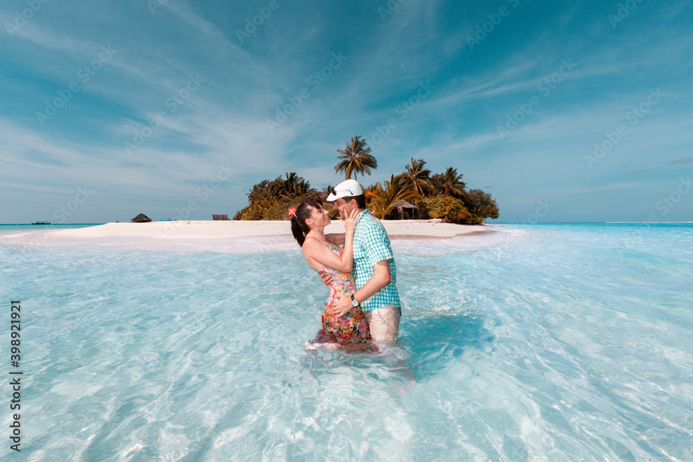 Young couple kissing on the sea beach in Maldives Young couple kissing on the sea beach in Maldives