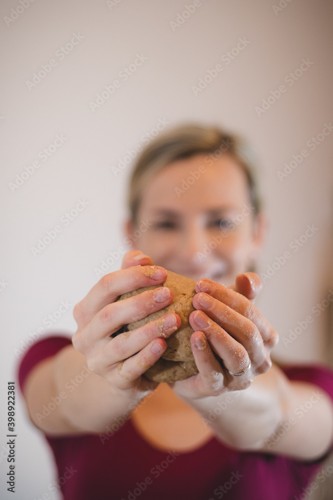 beautiful, hair-in-braid cook holds a special dough for the best Christmas cookies. Preparing sweets for the Christmas holidays. Flour, rum, egg and baking powder dough beautiful, hair-in-braid cook holds a special dough for the best Christmas cookies. Preparing sweets for the Christmas holidays. Flour, rum, egg and baking powder dough