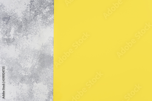 Light gray concrete and yellow background. Colors of the Year 2021 concept. Top view, flat lay, copy space