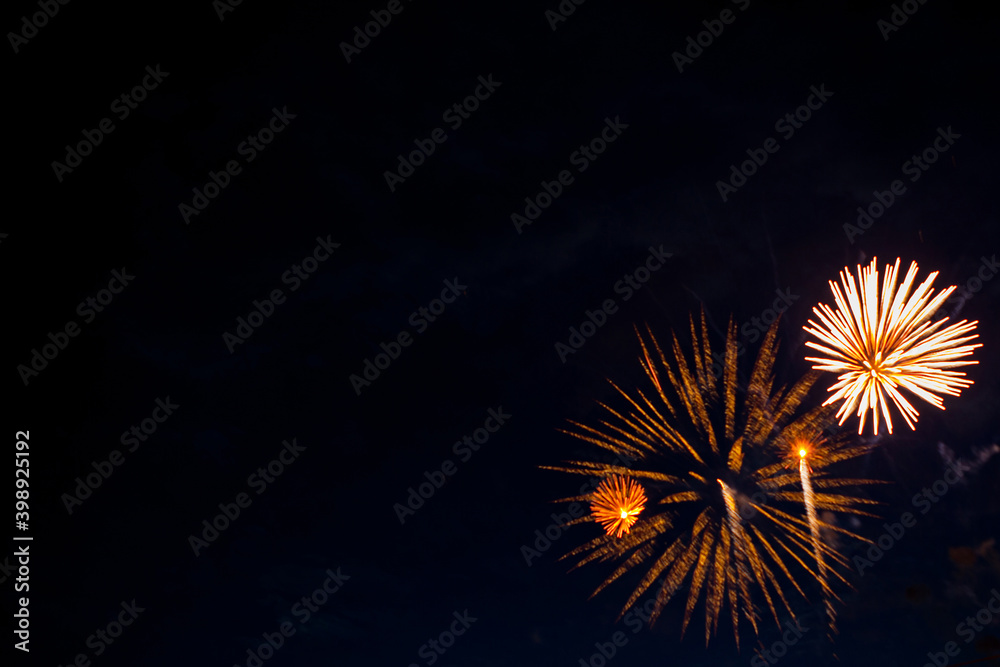 Beautiful fireworks for New Years, Independence Day or other holiday against the background of a dark sky Beautiful fireworks for New Years, Independence Day or other holiday against the background of a dark sky