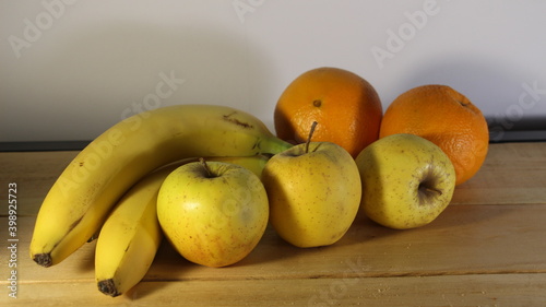 Beautiful yellow-green ripe apples and bananas on a beautiful background