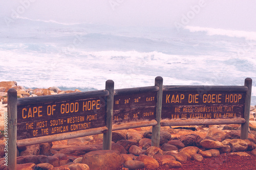 Cape of good hope sign with longitude and latitude coordinates for the most south-western point of Africa and a bilingual description of the site: english and afrikaans (Kaap die Goete Hoop) photo