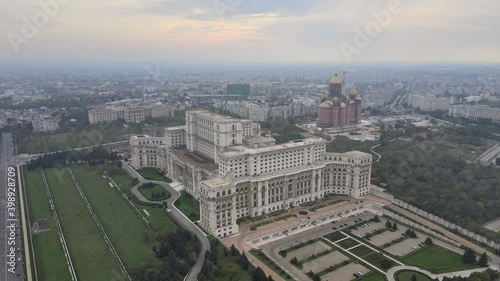Palace of the Parliament, aerial drone cityscape Bucharest historical communist building for Parliament of Romania central administration landmark tourism monument. Communism history sunset skyline