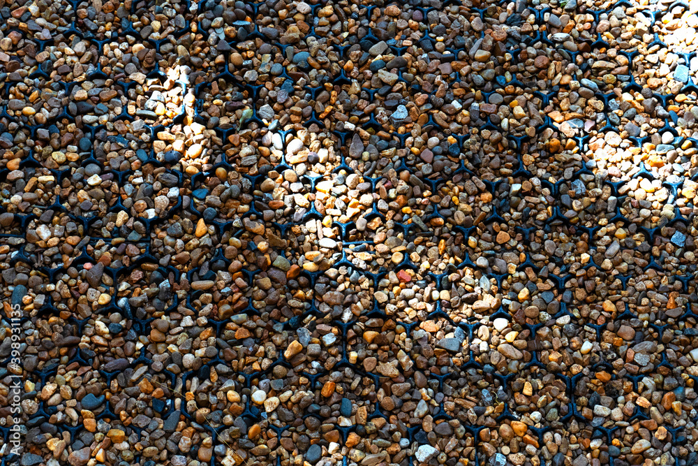 Background of the small rocks walk way with the light and shadow as solid pebble in the garden backyard Background of the small rocks walk way with the light and shadow as solid pebble in the garden backyard