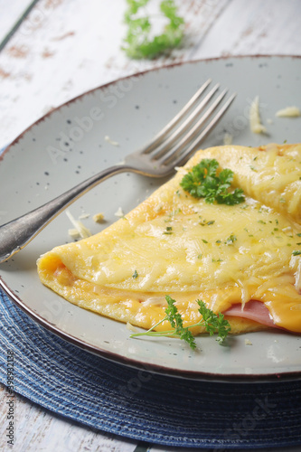 Omelette with ham and cheese on the plate