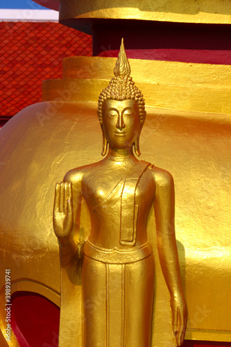 a golden buddha statue at a temple in thailand