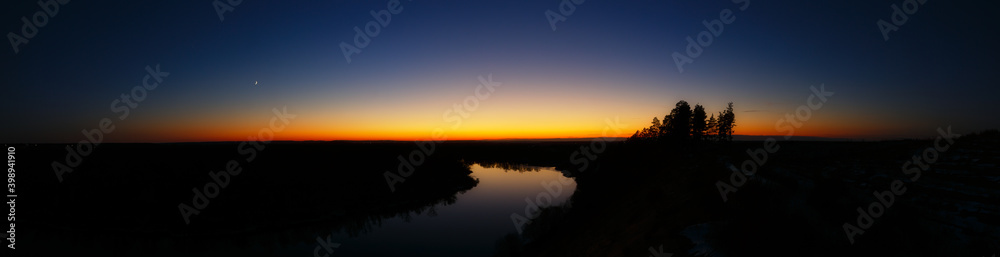Panoramic view of the river. Evening sky after sunset.